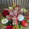 A classic Centerpiece of Christmas Greens, Flowers, Ornaments and Ribbon. Great for
