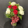 The Classic dozen roses is done up in style with a mix