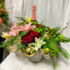 A gorgeous arrangement of Holiday flowers, Christmas greens, bows and d&eacute;cor including