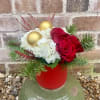 Red roses, white hydrangea and mixed inter greens arranged in a red