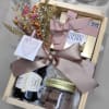 A bottle of wine in a box with chocolates.
Finely decorated with dried