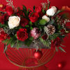 This striking floral arrangement features bold red blooms, such as rich red