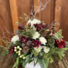 orchids, berries, mums, eucalyptus and evergreens in a rustic box