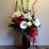 Blooming with Christmas cheer and holiday elegance, this stunning yuletide flower bouquet