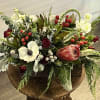 This elegant arrangement consists of veronica, protea, burgundy spray roses, berries, anemones