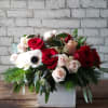 Rustic wood box arrangement of red and pink roses with anemone, eucalyptus