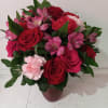 Beautiful reach red and pink colors roses, carnations and alstroemeria in a