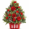 Bring holiday cheer home with Teleflora&#039;s Holiday Traditions Tree. This festive floral