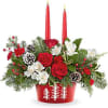 Evergreen Charm Centerpiece lights up the holidays with red roses, white blooms