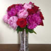 Mixed color Peonies  (if available) , Red Roses in tall silver