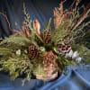 Indulge in an elegant arrangement of Christmas greens merged with holiday magic