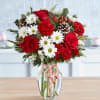 Beautiful Christmas bouquet with two candy canes in a clear vase 