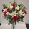 Silver tall vase with 6 red roses, Christmas greens, 3 white lilies