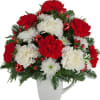 A re-usable mug is arranged with red and white blooms for Christmastime.
