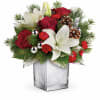 With its festive charm and classic Christmas style, this hand-arranged bouquet delivered