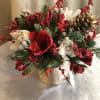 A decadent floral display of seasonal red and white toned floral blossoms
