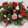 This centerpiece is a combination of red and peppermint carnations and mini
