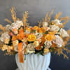 &ldquo;A vibrant blend of orange, peach, and yellow blooms &mdash; warm, sun-kissed