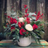 A glamorous grouping of seasonal greens with pops of red and white