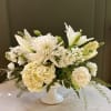An all white and green winter floral design for moments that deserve