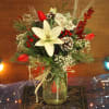 Asiatic lilies and tulips are included in this natural design arrangement in