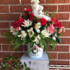Share some holiday cheer in this Christmas tin. This arrangement is made