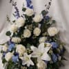 Beautiful flowers to surround your loved one.  Includes delphinium, roses, lilies