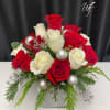 Red and white roses accented with frosted ornament balls in a low