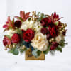 The Gilded Holiday Cheer Bouquet radiates sophistication with a festive twist. Featuring