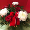 Roses,  Cremons, Gerbera Daisies, Hypericum, Holly , White Pine, Fancy Seasonal