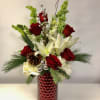 Tall vase with mixed evergreen white lilies red roses Bill of Ireland