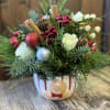 Bring the cozy charm of Christmas with a delightful arrangement mad in