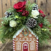 This Festive Gingerbread house embodies the holiday spirit. Filled with seasonal greens