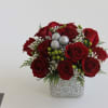 Send your Christmas love with this hand-tied centerpiece of red roses, snowy
