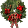 Natural green holiday wreath. Decorated with red Christmas blubs, pinecones and beautiful