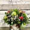 This beautiful new arrangement is filled with winter greens from the forest.
