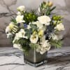 Blue and white holiday arrangement, with white hydrangea, lisianthus, white carnations, thistle