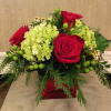 Green Hydrangea, Red Roses, Festive balls and Red Hypericum are nestled in