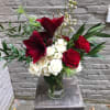 A holiday arrangement with height! Presented in a clear glass vase with