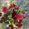 Colorful seasonal blooms, accented with cones, twigs, berries and red cardinals.