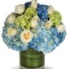Our exclusive design included white roses, blue hydrangea and a hint of