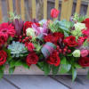 Flower box centerpiece is created with premium flowers arranged in a wooden