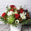 A premium, rustic Christmas arrangement in a keepsake tin! Includes roses, anemones