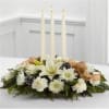 Winter white lilies, carnations and cushion pompons glow brightly from a bed