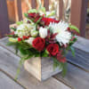 A delightful design of seasonal blooms in a hand crafted wooden box.