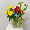 This Medium Tall arrangement includes Yellow Gerbera Daisies, Hot Pink Roses, Blue