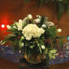 Large, elegant arrangement of all white flowers with Christmas pine, Christmas balls.