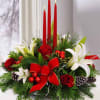 Winter white lilies and our freedom red roses are nestled among a