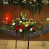Large centerpiece with unusual flowers such as protea, lotus pods, green spider
