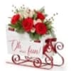 Sled into the holiday season with this lush arrangement of red roses
